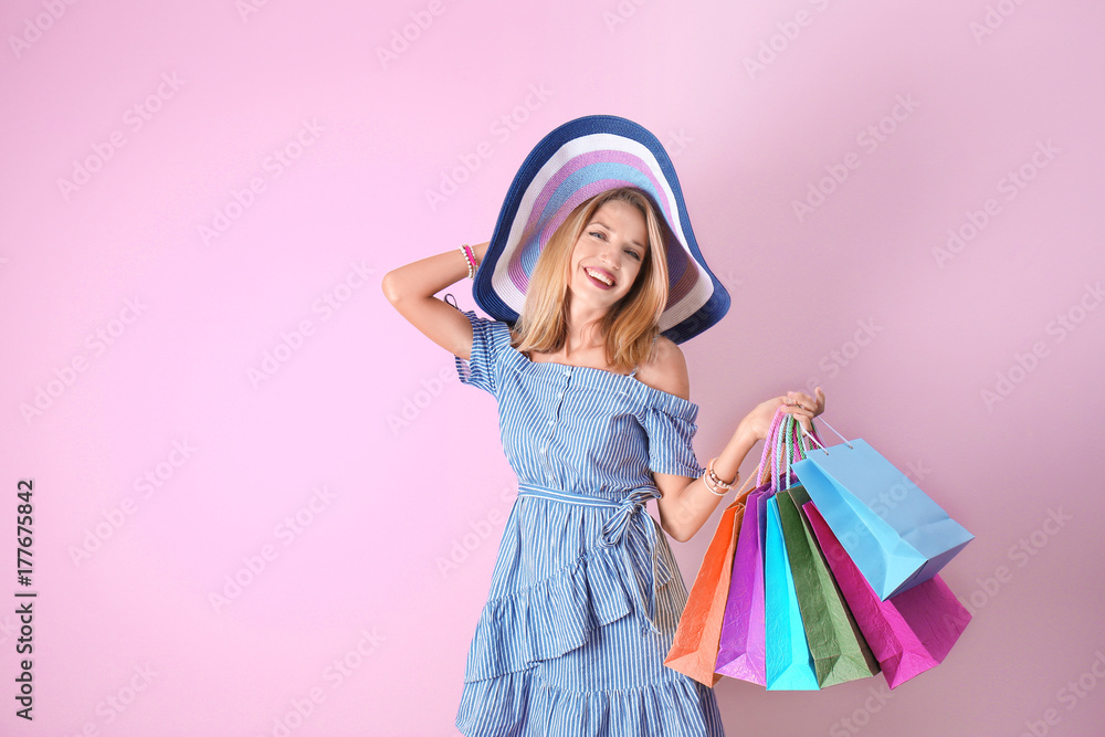 Beautiful woman with paper bags on pink background Beautiful woman with paper bags on pink background