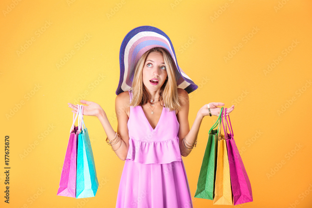 Beautiful woman with paper bags on yellow background Beautiful woman with paper bags on yellow background
