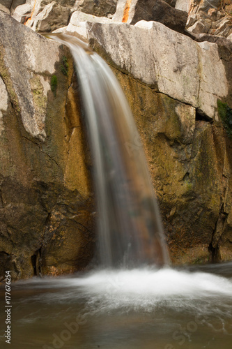 Waterfall on a mountain river with blurred water