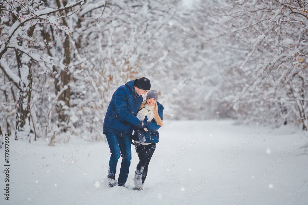 Fototapeta premium Happy Couple Having Fun Outdoors in Snow Park. Winter Vacation