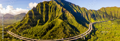 Green cliffs and mountains on the island of Oahu, Hawaii with the world famous Haiku stairs or the stairs to heaven.  photo