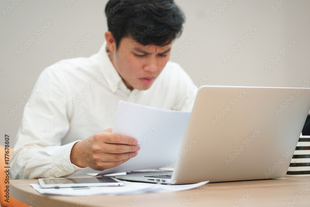 close up man hand holding paperwork for reading with stress and serious feeling , work hard and unhealthy concept close up man hand holding paperwork for reading with stress and serious feeling , work hard and unhealthy concept