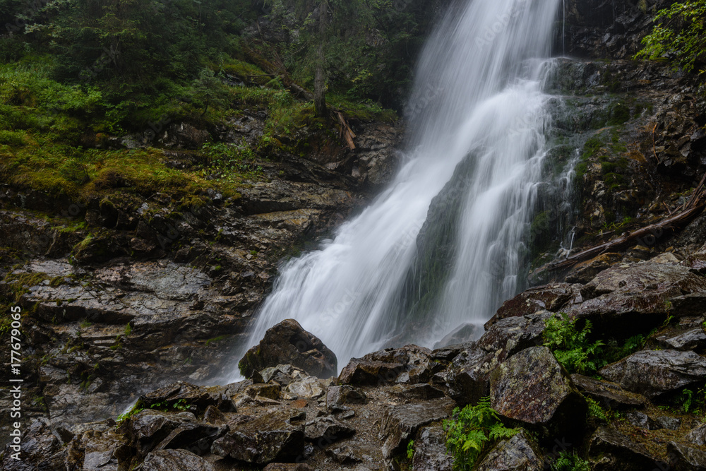 large Waterfall from ravine in autumn, long exposure