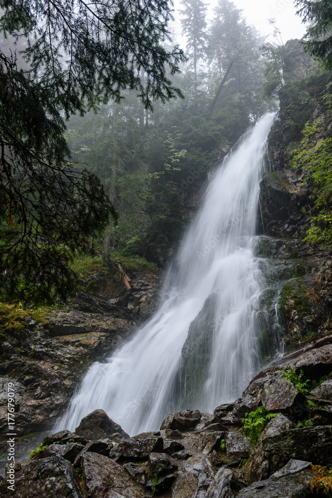 large Waterfall from ravine in autumn, long exposure