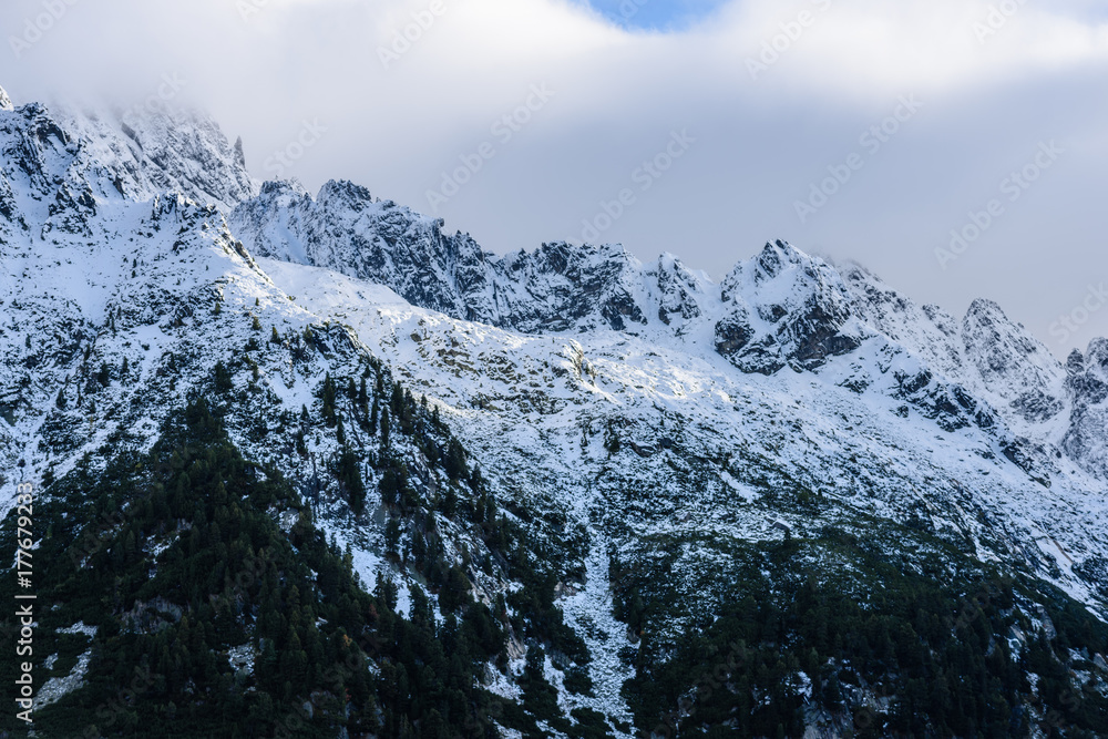 panoramic view of Tatra mountains in Slovakia covered with snow and hiding in mist