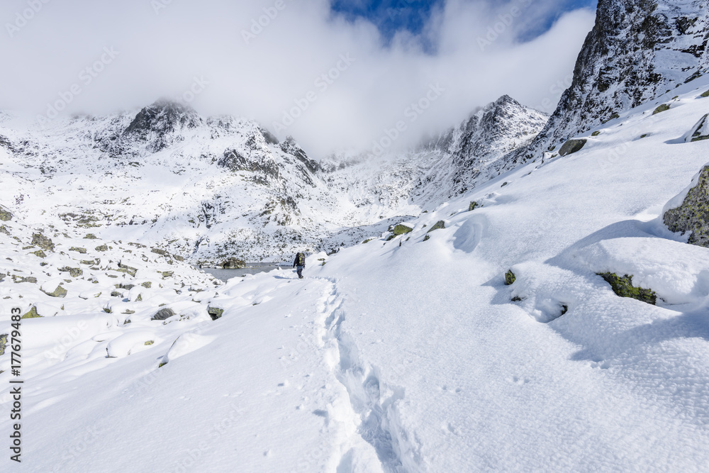 panoramic view of Tatra mountains in Slovakia covered with snow and hiding in mist panoramic view of Tatra mountains in Slovakia covered with snow and hiding in mist