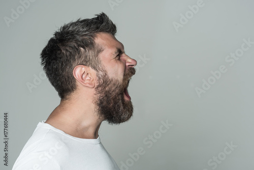 man with long beard on angry face