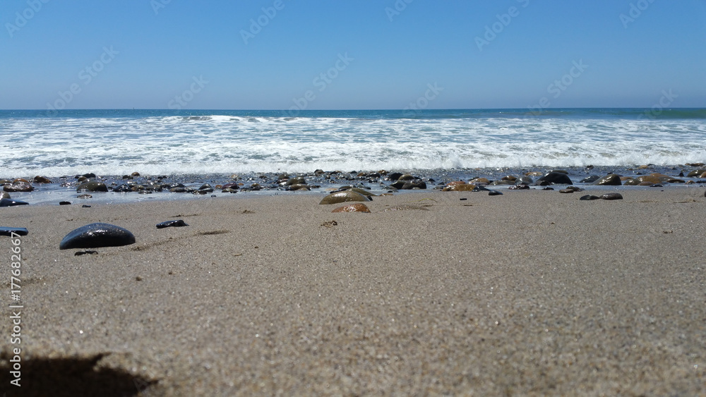 Waves on rocky beach series - sand level Waves on rocky beach series - sand level