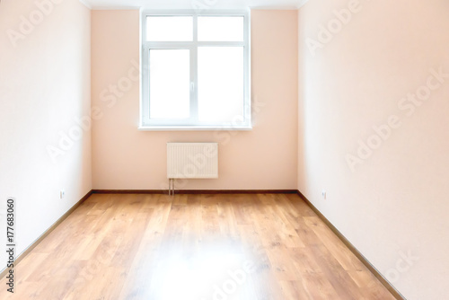 Empty room with window and wooden floor