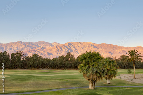 The sun setting at Furnace Creek in Death Valley  photo