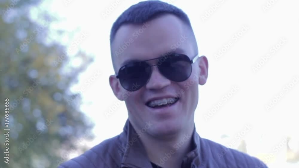 Portrait of happy young man. Nice smile with Dental braces. Slowmotion Portrait of happy young man. Nice smile with Dental braces. Slowmotion