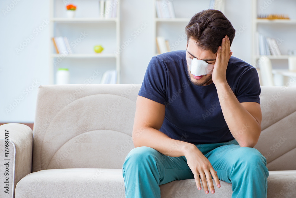 Young man recovering healing at home after plastic surgery nose Young man recovering healing at home after plastic surgery nose