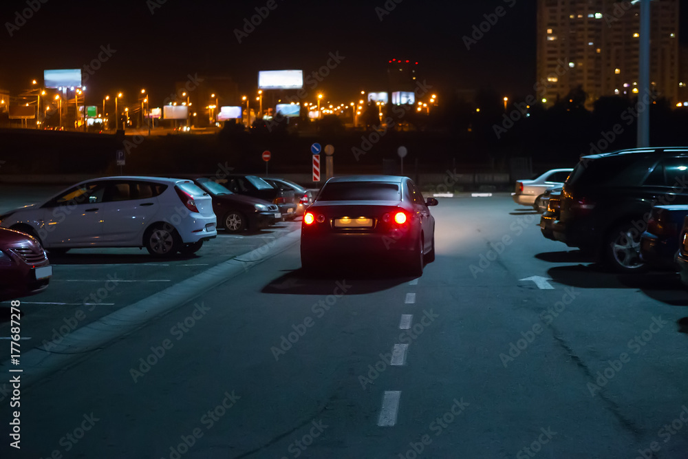Cars at night in a parking lot