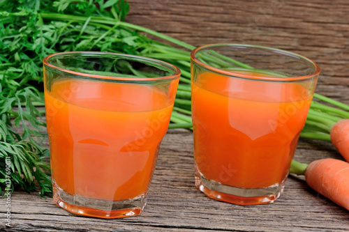 Glasses of fresh carrot juice on table