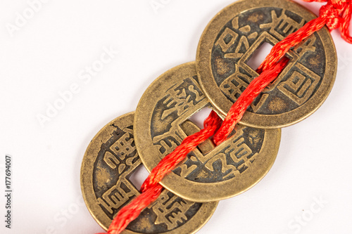 Three ancient Feng shui metal lucky coins isolated above white background