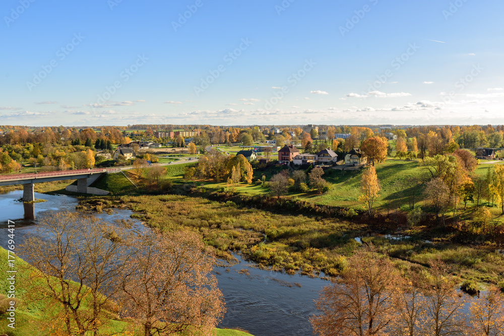Aerial view on panorama of autumn valley with river and bridge near Bauska town, Latvia