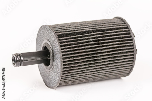 Old used and dirty car fuel filter isolated above white backgrou