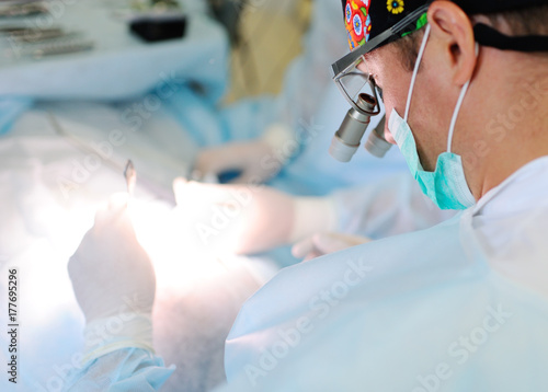 surgeons do surgery in a modern operating room or clinic photo