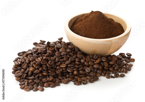 Coffee beans with ground coffee in wooden bowl