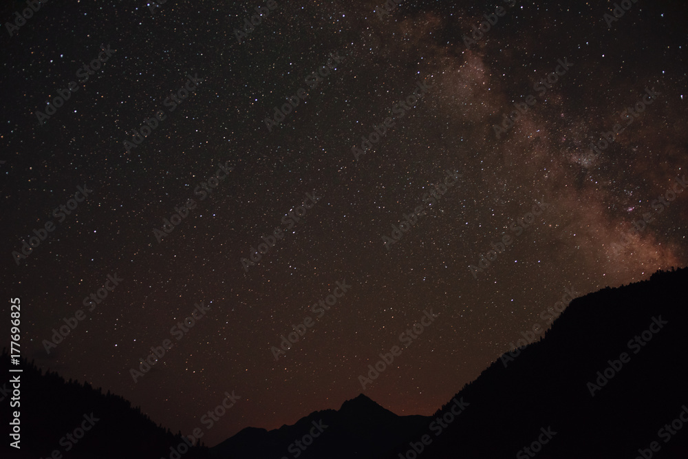 Milky Way on night sky with a lot of stars above mountains in Abkhazia