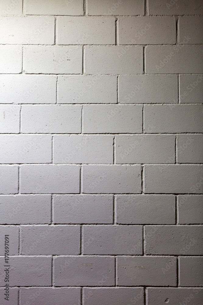 Naklejka premium Textured surface of the gray painted brick wall 