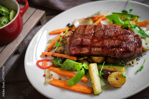 grilled Striploin steak with vegetables on plate