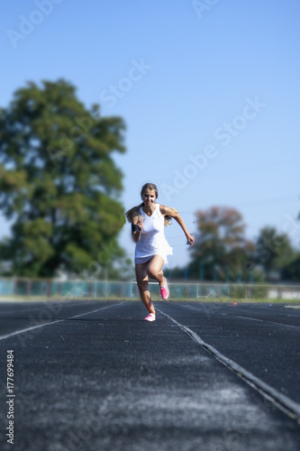 Beautiful athlete on a race track is ready to run