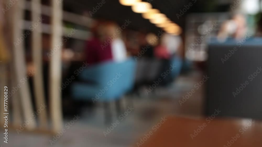 Defocused background - a group of people is sitting in a modern restaurant. Defocused background - a group of people is sitting in a modern restaurant.