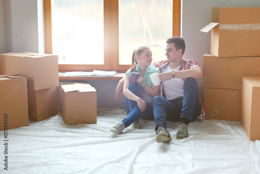 Couple moving in house sitting on the floor. Couple Couple moving in house sitting on the floor. Couple