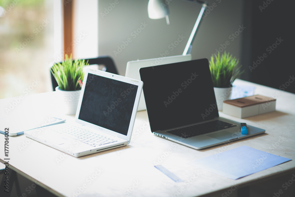 Fototapeta premium Young woman sitting at office table with laptop. Young woman. Laptop
