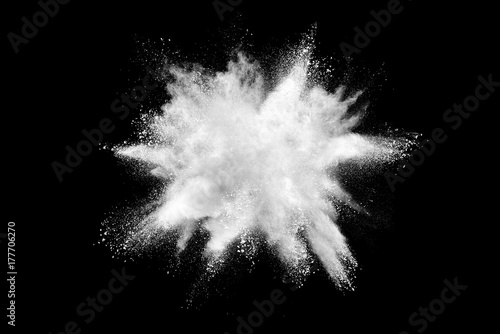 Explosion of white powder isolated on black background.