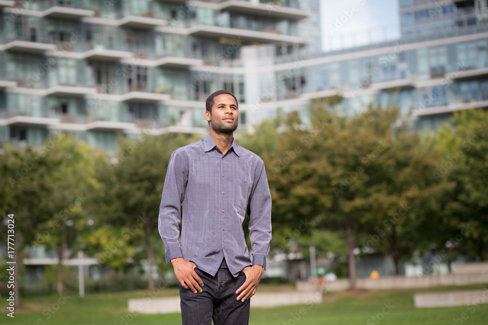 Portrait of young African American man in residential neighborhood in the city Portrait of young African American man in residential neighborhood in the city