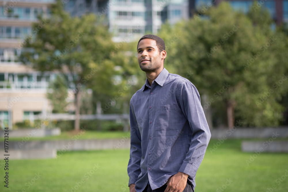 Portrait of young African American man in residential neighborhood in the city Portrait of young African American man in residential neighborhood in the city