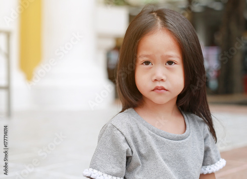 Cute asian child girl outdoor. Portrait beautiful girl looking something.