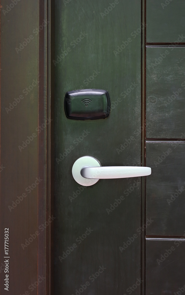 Door handle with access key on wooden door. Door handle with access key on wooden door.
