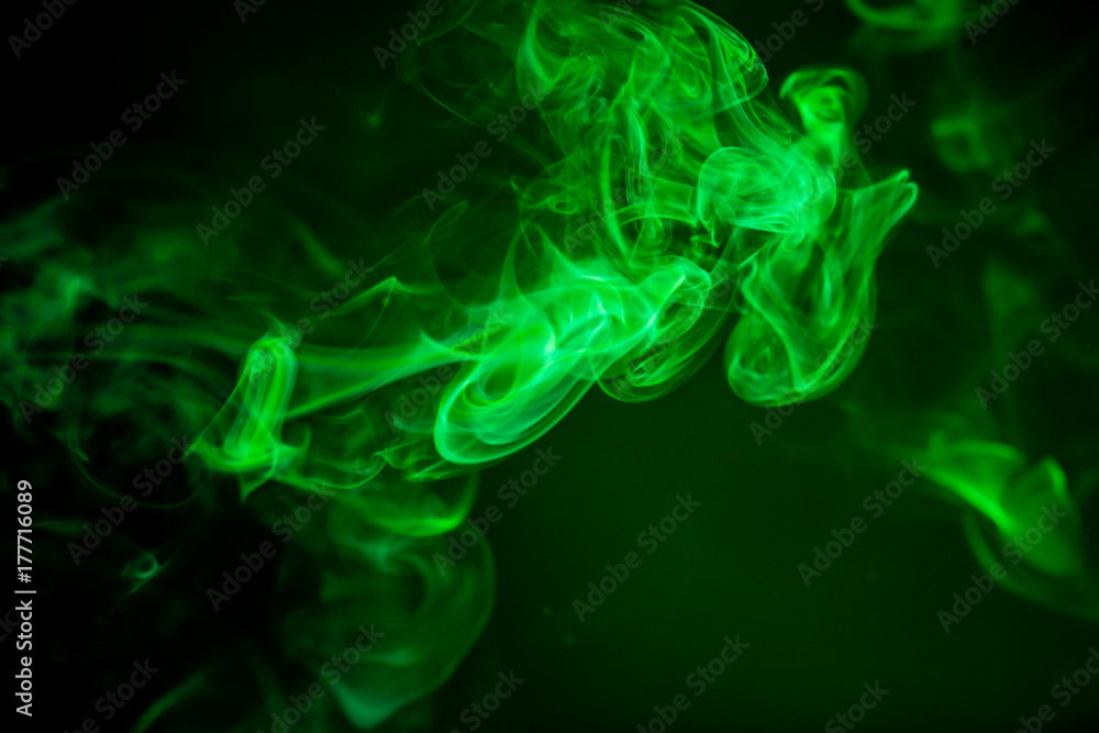 Fototapeta premium Green smoke motion on black background.