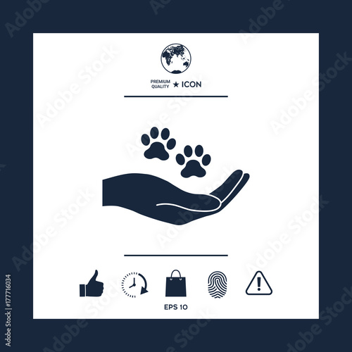 Hand holding paw symbol. Animal protection