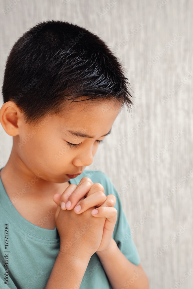 asian boy child praying with eyes closed, christianity faith concept asian boy child praying with eyes closed, christianity faith concept
