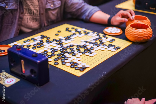 Chinese GO board game  close up view of playing.
Weiqi or Weichi 