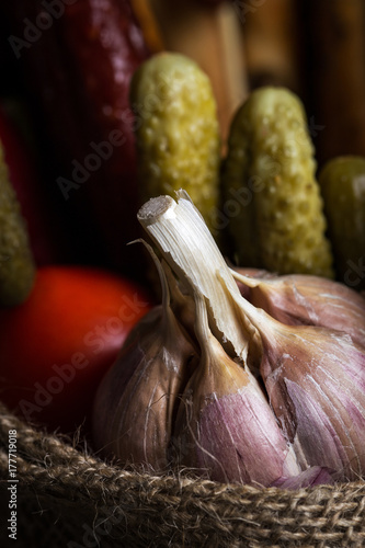 Garlic. Garlic on the bag. In the background vegetables. photo