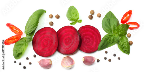 sliced beetroot with basil isolated on white background. top view