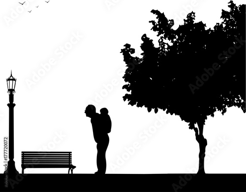 Grandfather carrying a grandchild piggyback in park, one in the series of similar images silhouette