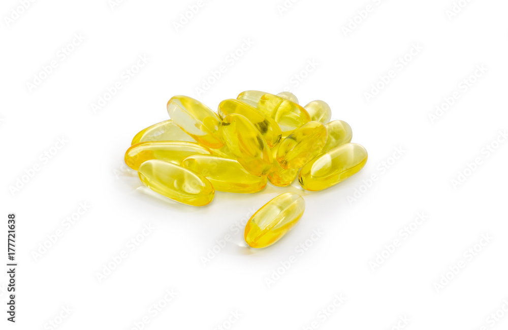 Yellow capsules with dietary supplements on a white background Yellow capsules with dietary supplements on a white background