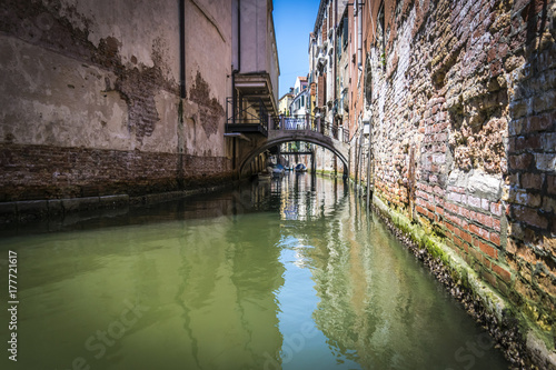 Canals and historic buildings of Venice, Italy. Narrow canals, old houses, reflection on water on a summer day in Venice, Italy.