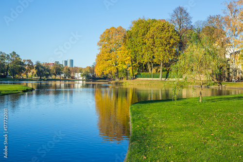 Pond in Riga, district agenskalsns. Autumn, yellow tree leaves, lake and reflection. 2017