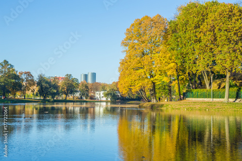 Pond in Riga, district agenskalsns. Autumn, yellow tree leaves, lake and reflection. 2017