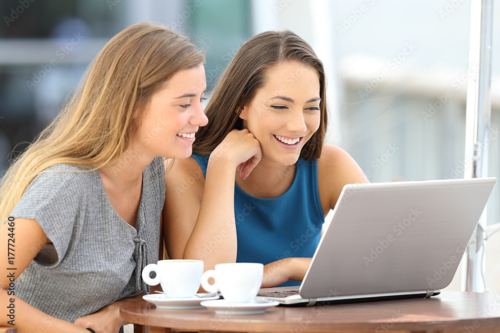 Two friends watching streaming content on line Two friends watching streaming content on line