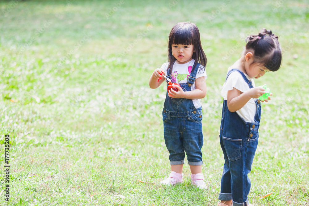 Fototapeta premium Cute Kids 2-3 Year Old Playing Bubble in the garden