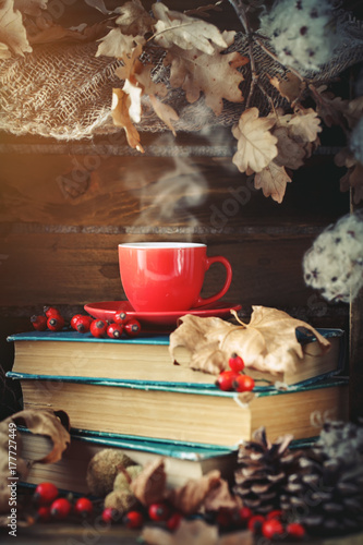 Autumn still life with a cup of coffee, apples and autumn leaves. Autumn background. photo