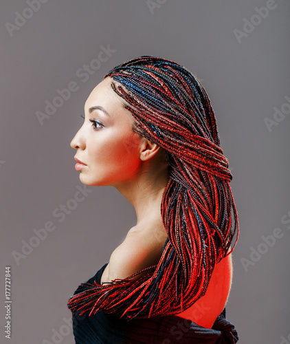 Tablou pe pânză Women Hairstyle with colorful hair extensions braided in thin plaits and afrobra
